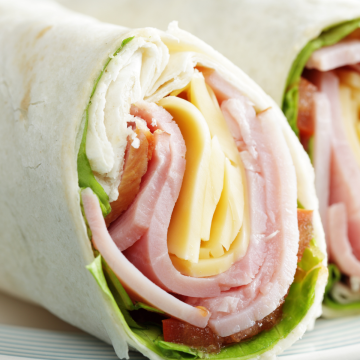 ham and cheese roll up on a tortilla