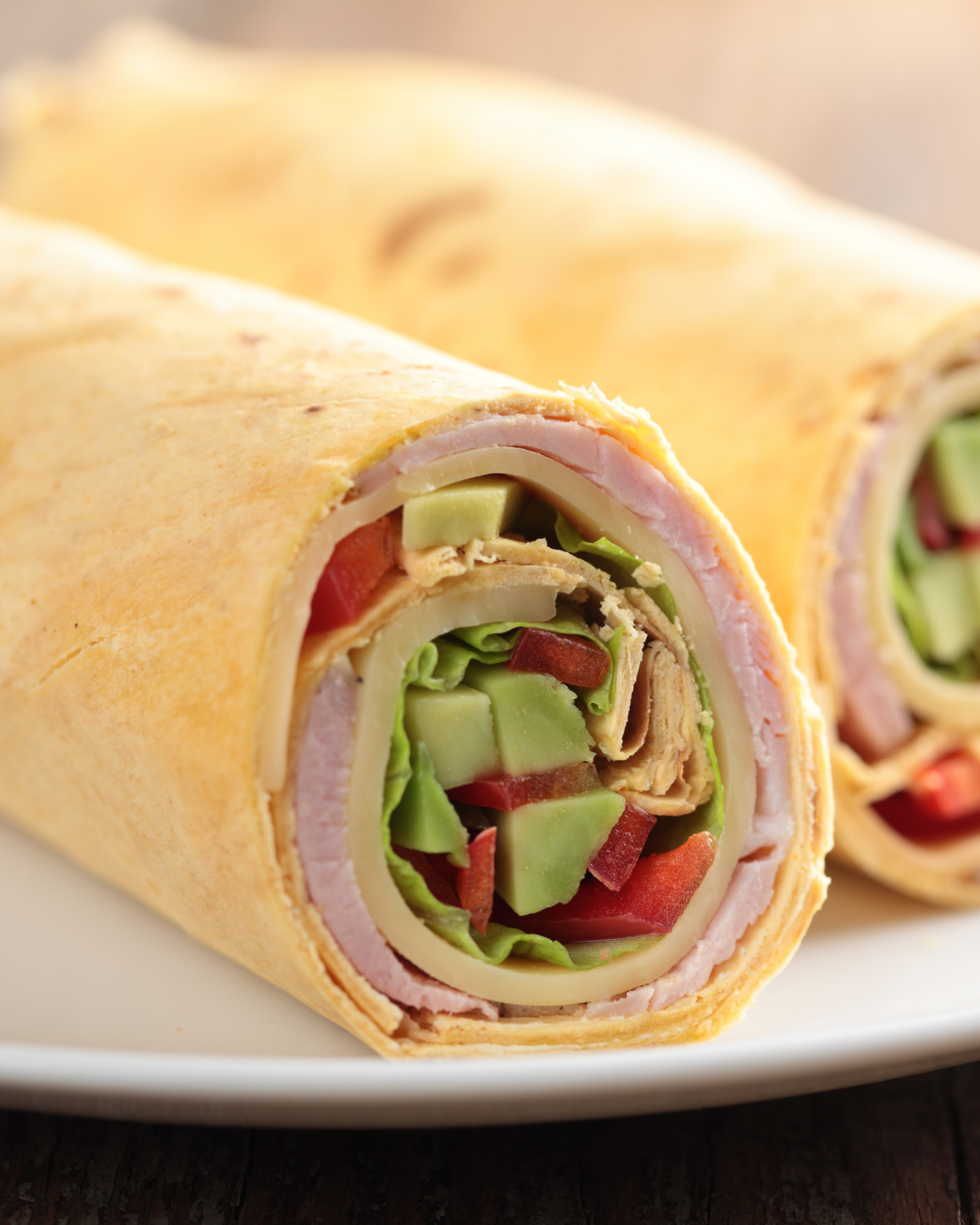 ham and cheese roll up on a tortilla