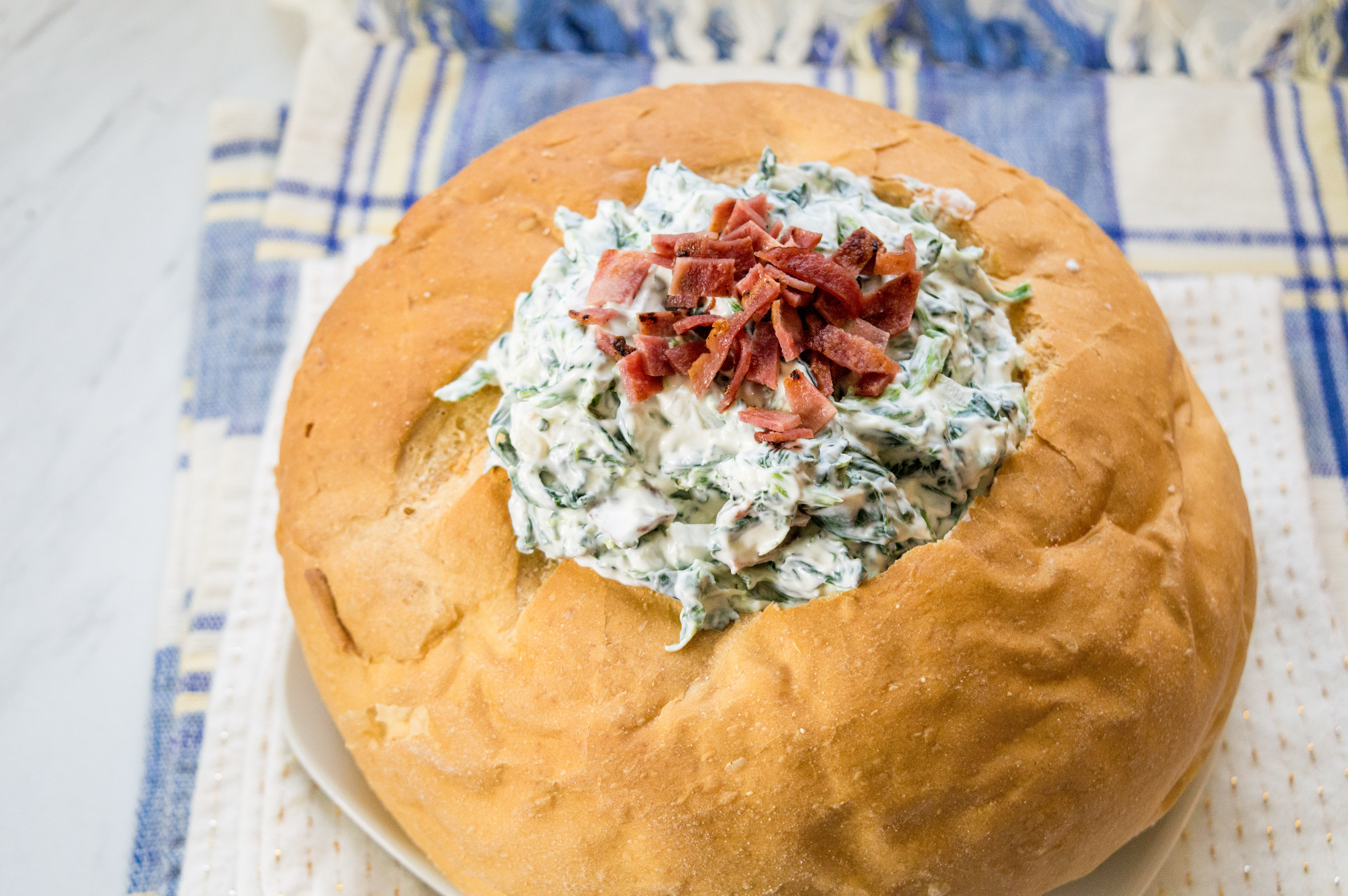 Love spinach dip? So do I. This spinach dip recipe, an easy pot luck recipe, will leave you craving more once you add my special ingredient. Bacon! 