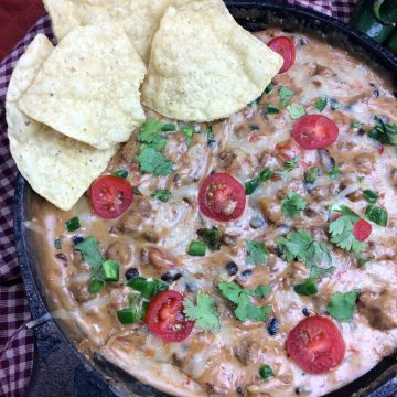 Looking for a good cheese dip recipe? I have just what you need. This Cowboy Queso Dip recipe is perfect if you are looking for a spicy cheese dip or a cheese dip with meat in it. This is going to be a crowd pleaser recipe for any picnic or get together.