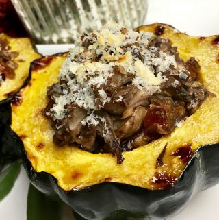 Looking for an acorn stuffed squash recipe? This is a protein packed dish that is filled with packed flavor. It can easily be changed to be a vegetarian stuffed acorn recipe. Enjoy this fall recipe for a delicious weeknight dinner.