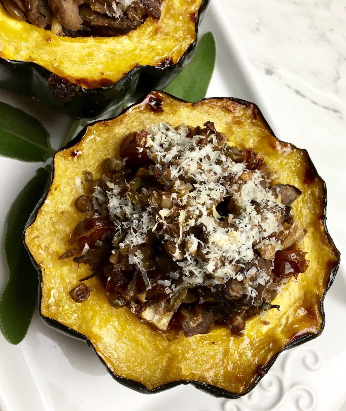 Looking for an acorn stuffed squash recipe? This is a protein packed dish that is filled with packed flavor. It can easily be changed to be a vegetarian stuffed acorn recipe. Enjoy this fall recipe for a delicious weeknight dinner.