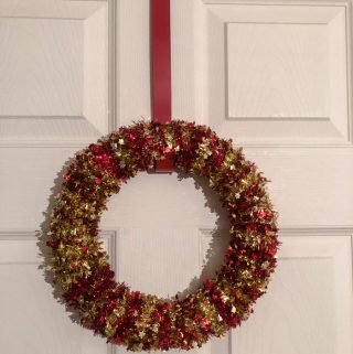 Looking for a simple DIY Christmas craft? This simple Christmas wreath is made from materials found at the dollar store and only costs $6 and a few minutes to make.