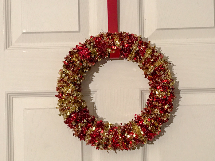 Looking for a simple DIY Christmas craft? This simple Christmas wreath is made from materials found at the dollar store and only costs $6 and a few minutes to make.