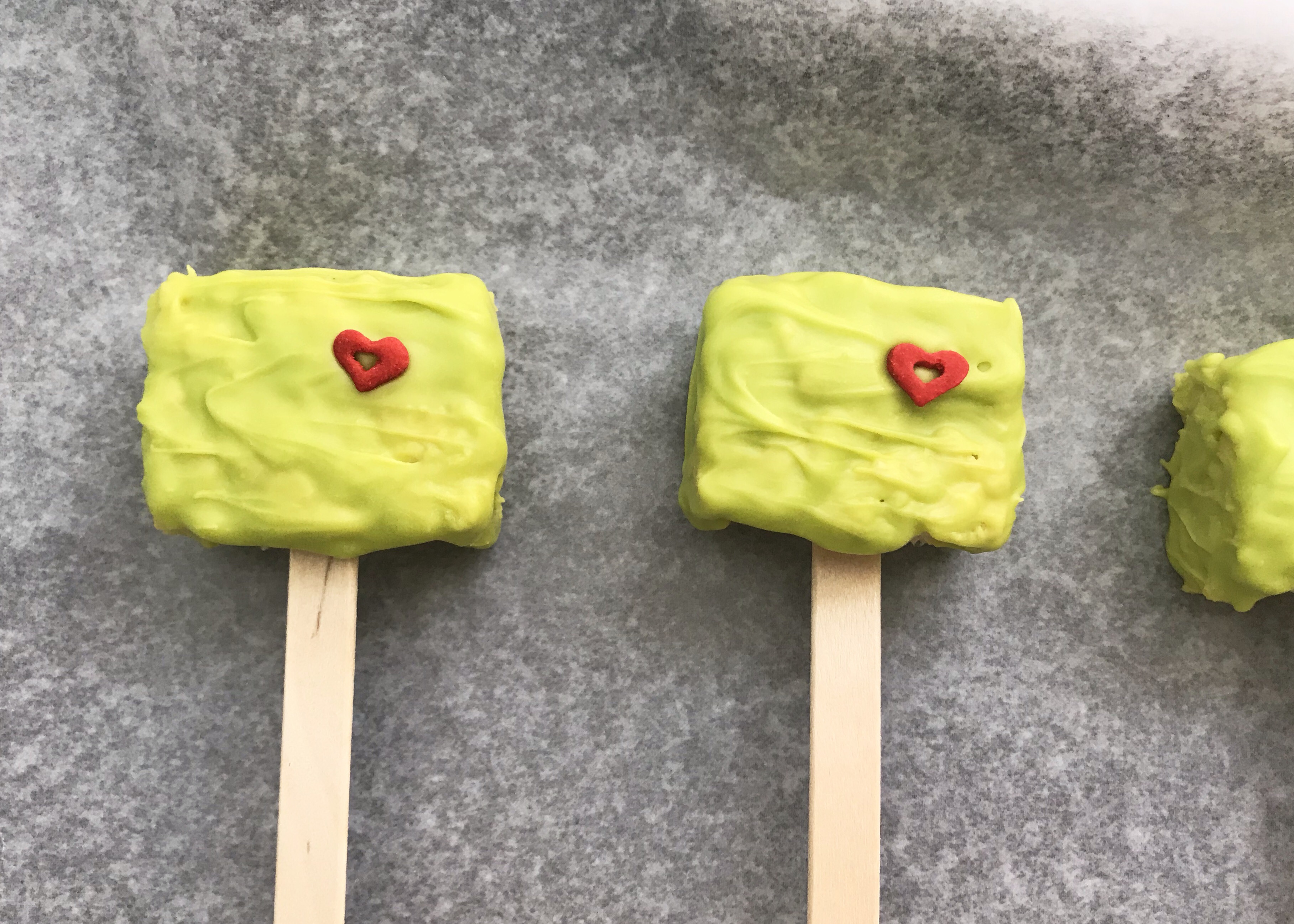 Looking for a fun Grinch treat? These simple to make Grinch Pops, which are Grinch Rice Crispy Treats will be a hit whether you make them for the kids, for a party or for a get-together. I think even the Grinch's heart would grow with these easy Christmas treats.