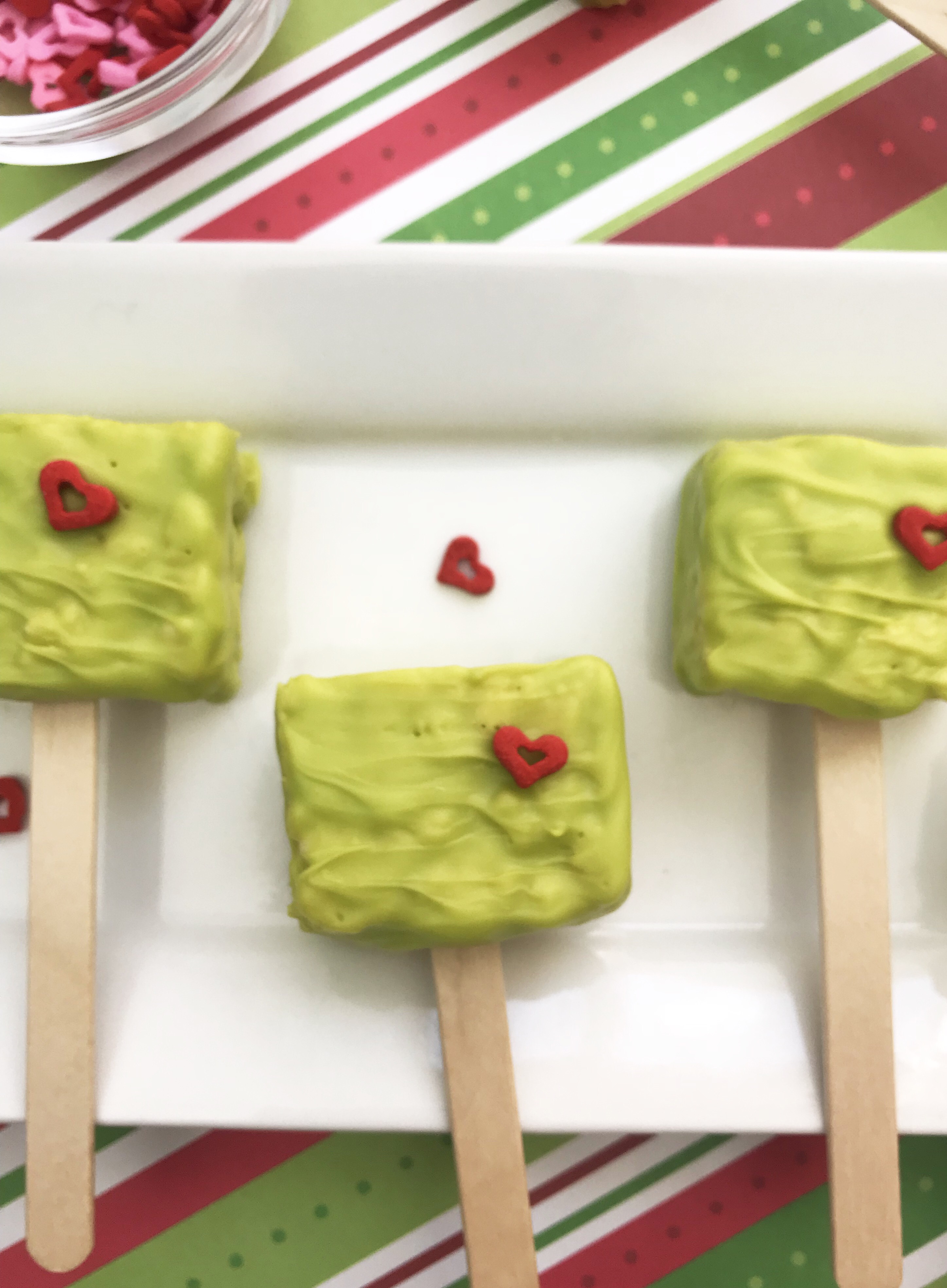 Looking for a fun Grinch treat? These simple to make Grinch Pops, which are Grinch Rice Crispy Treats will be a hit whether you make them for the kids, for a party or for a get-together. I think even the Grinch's heart would grow with these easy Christmas treats.