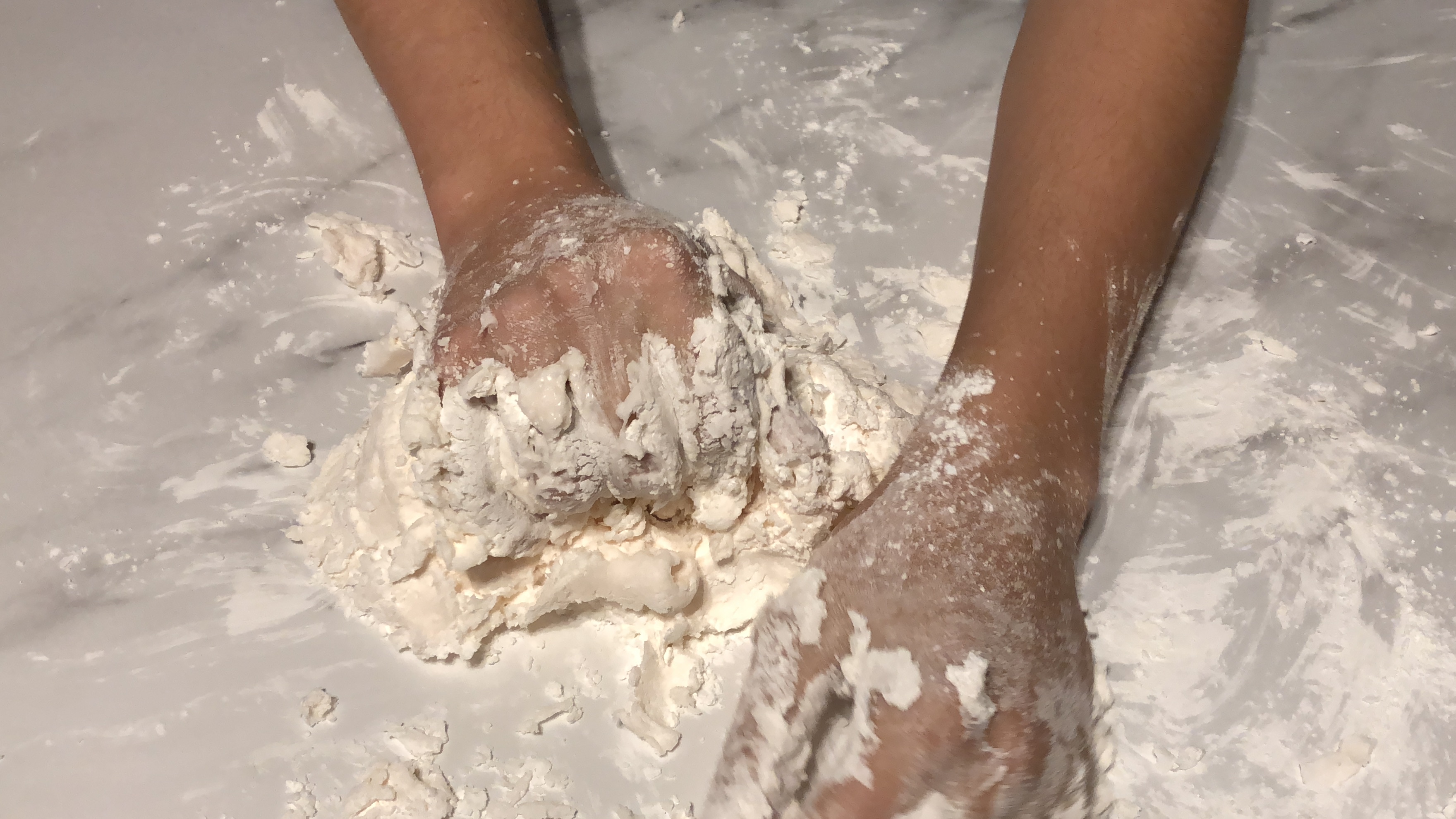 hands mixing moon dough