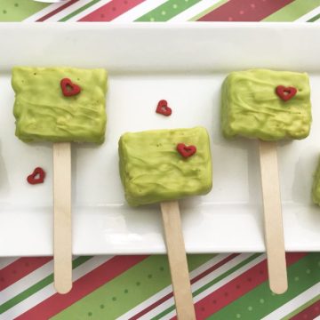Looking for a fun Grinch treat? These simple to make Grinch Pops, which are Grinch Rice Crispy Treats will be a hit whether you make them for the kids, for a party or for a get-together. I think even the Grinch's heart would grow with these easy Christmas treats.