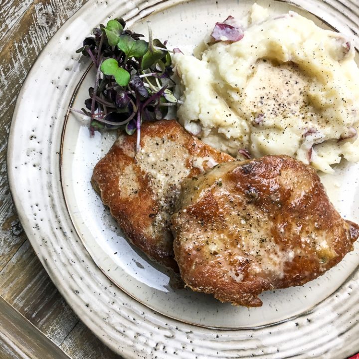 vertical picture of Instant Pot pork chops on a plate