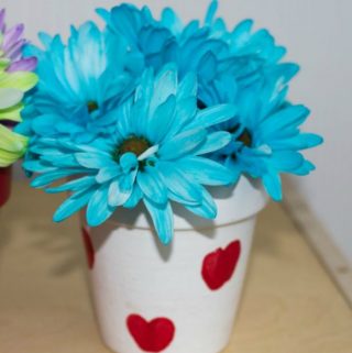 blue flowers in white flow pot craft