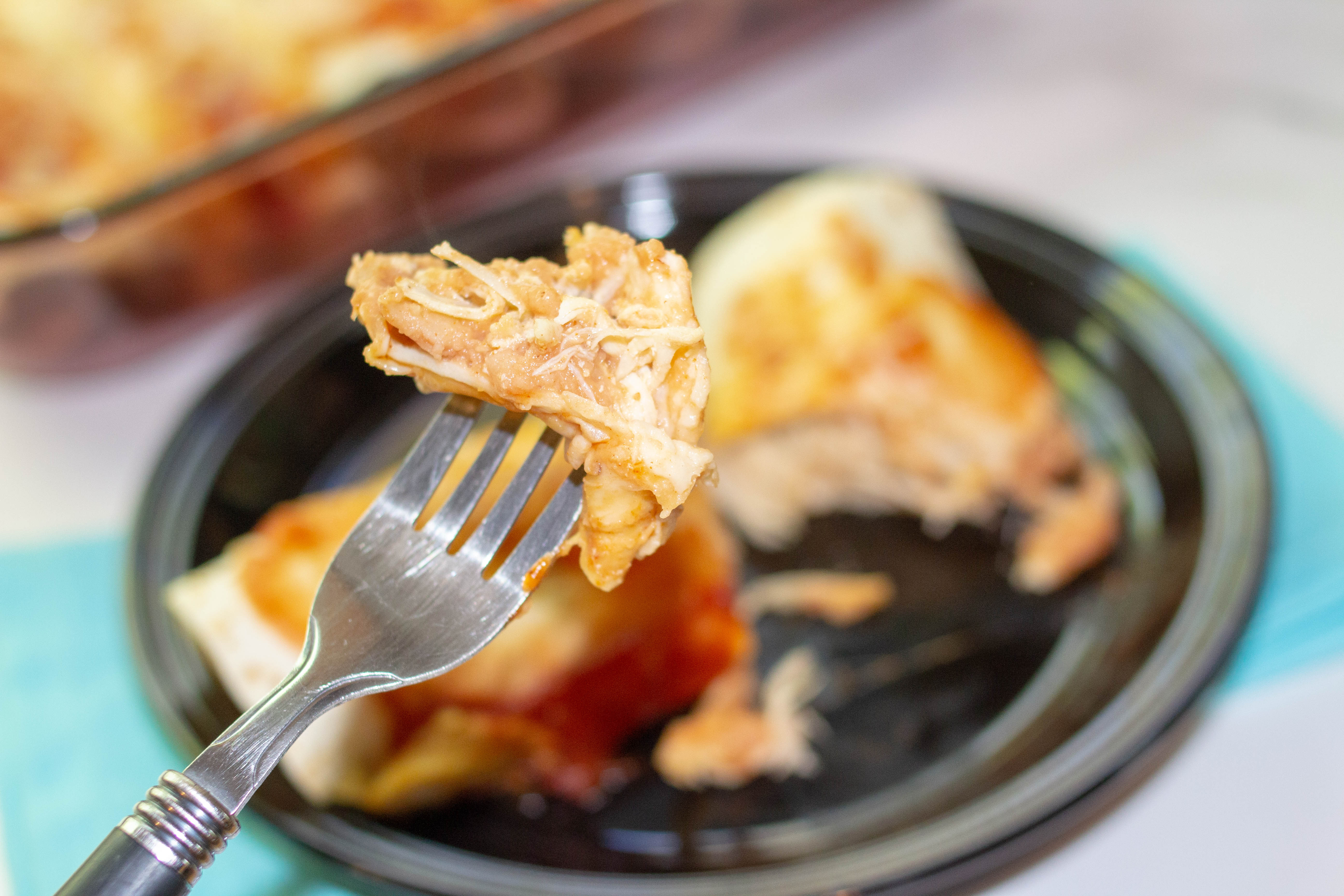 chicken enchilada on a fork