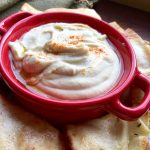 white bean dip in a red bowl
