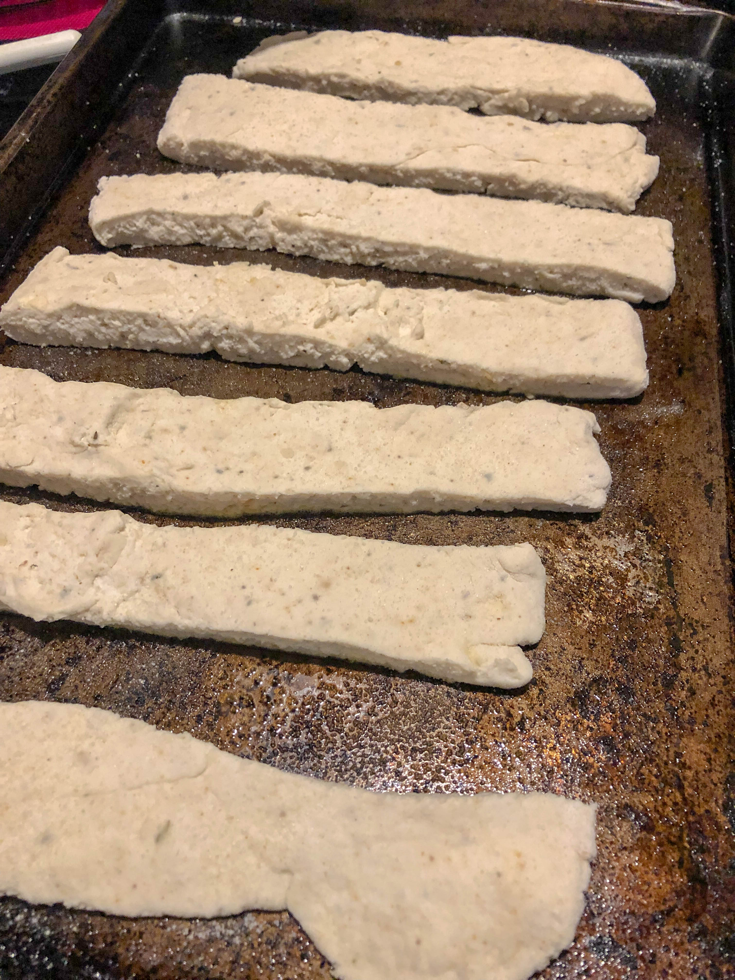 breadstick dough on a cookie sheet ready for the oven