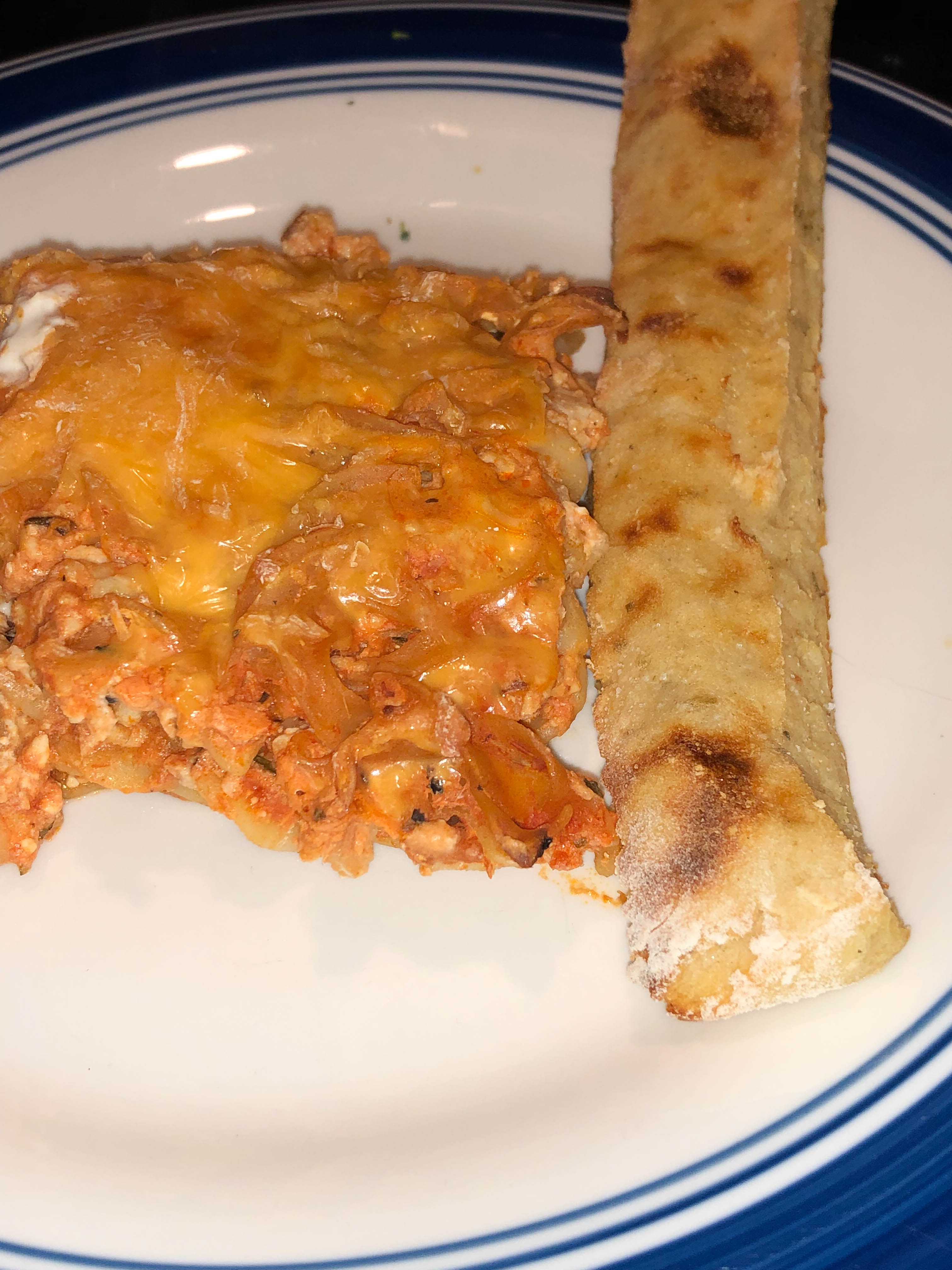 slice of million dollar spaghetti with a 2 ingredient dough breadstick