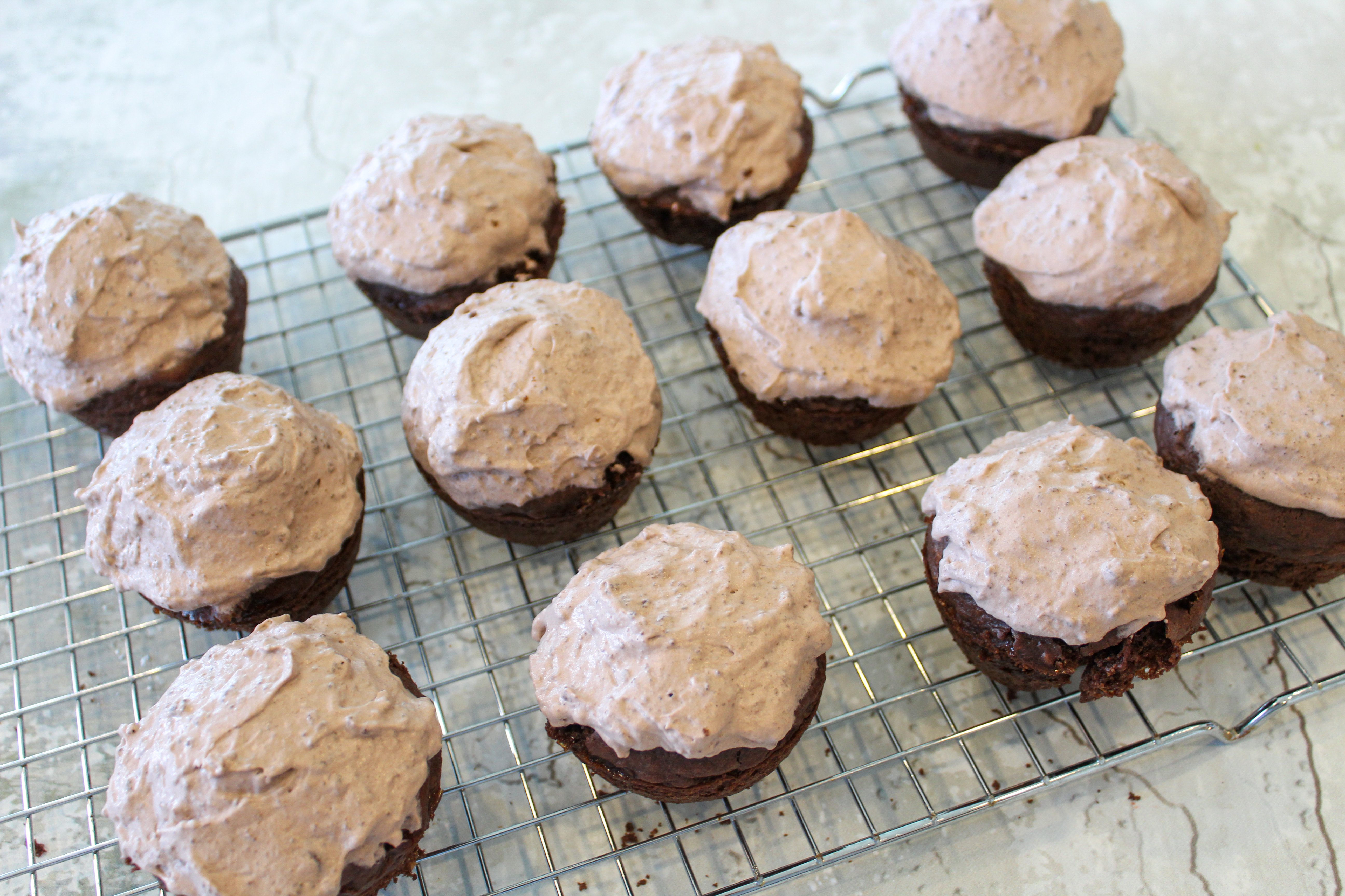 iced cupcakes on a cooling rack