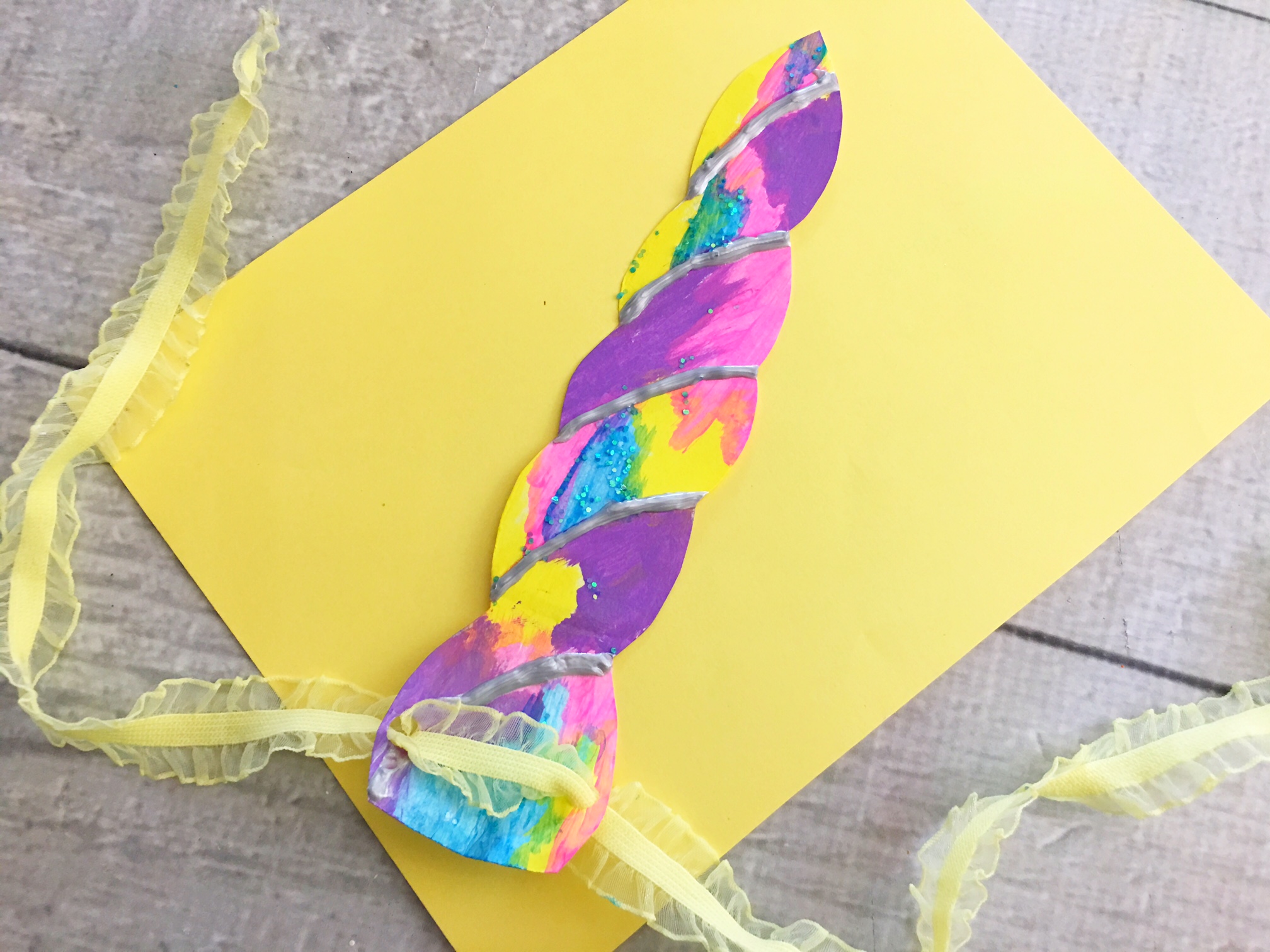 unicorn horn against a yellow paper