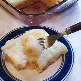 lemon cake on a plate with a bite on the fork