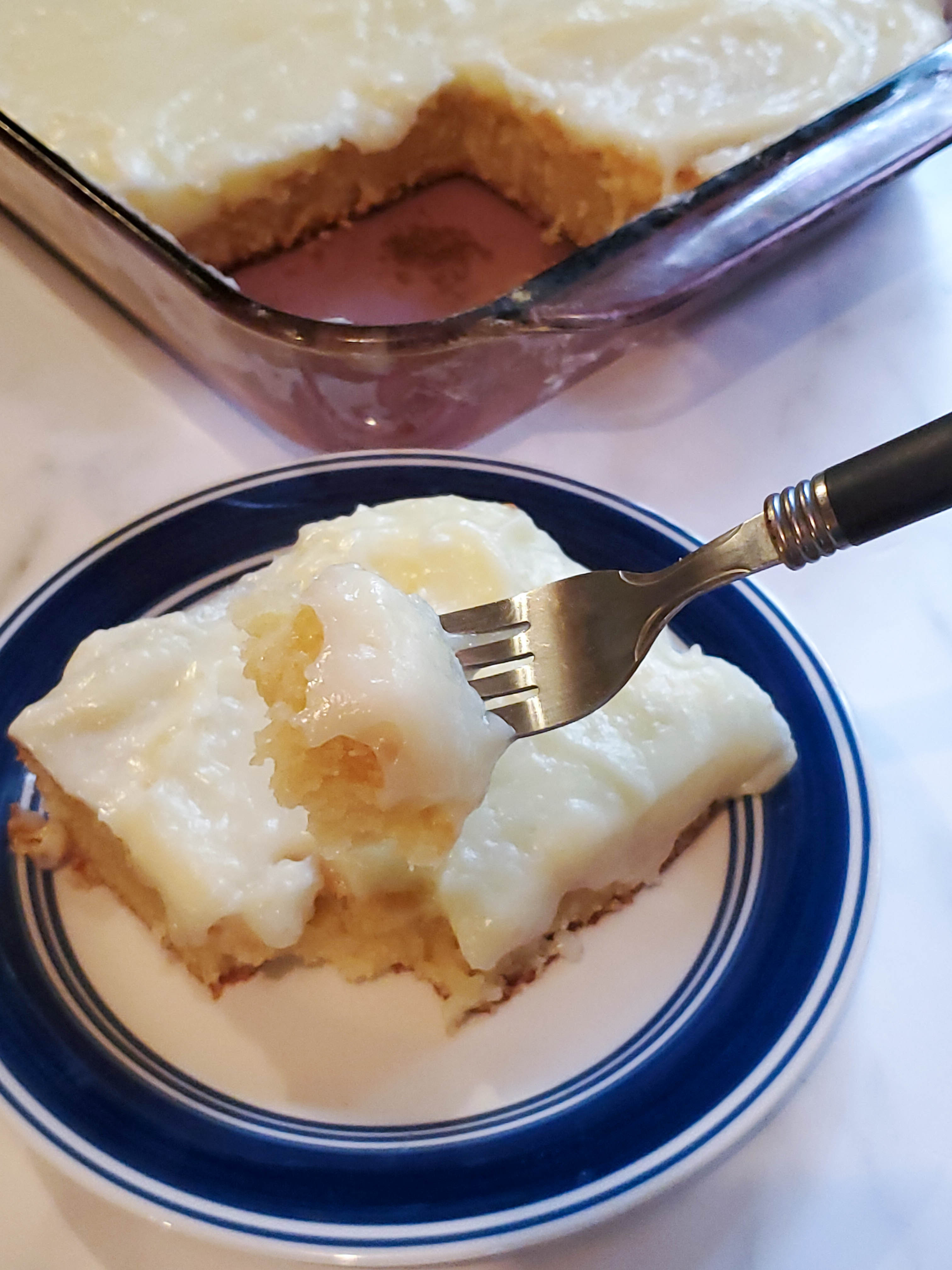 lemon cake on a plate with a bite on the fork