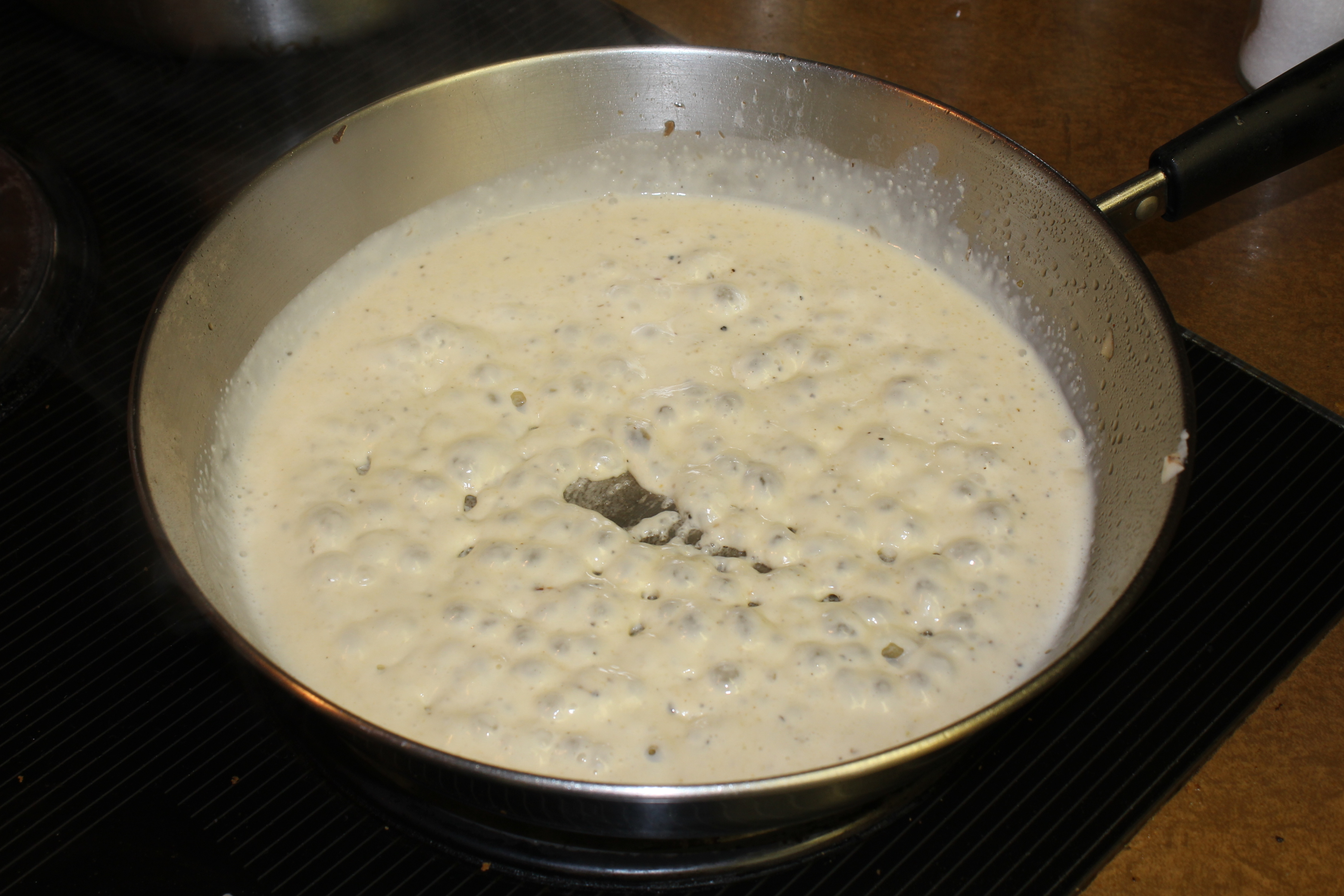 heavy cream cooking in a pot