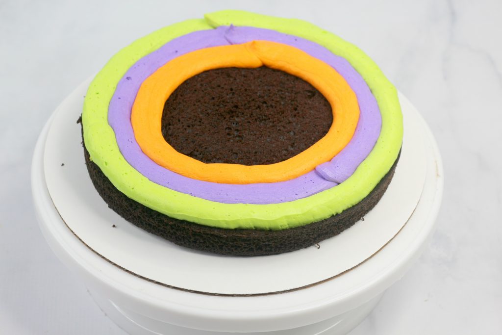 chocolate cake with green, purple and orange frosting