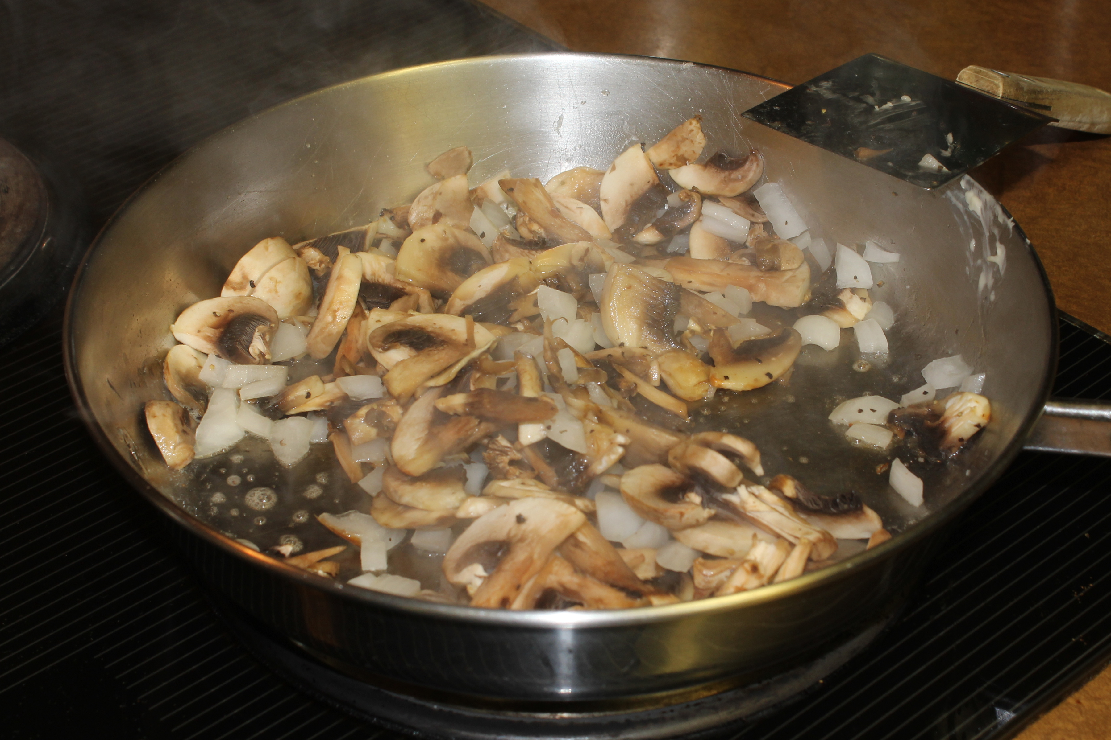mushrooms cooking down in a pan