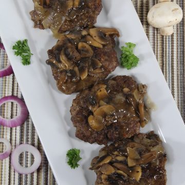 keto sausage burger with keto gravy on a white plate
