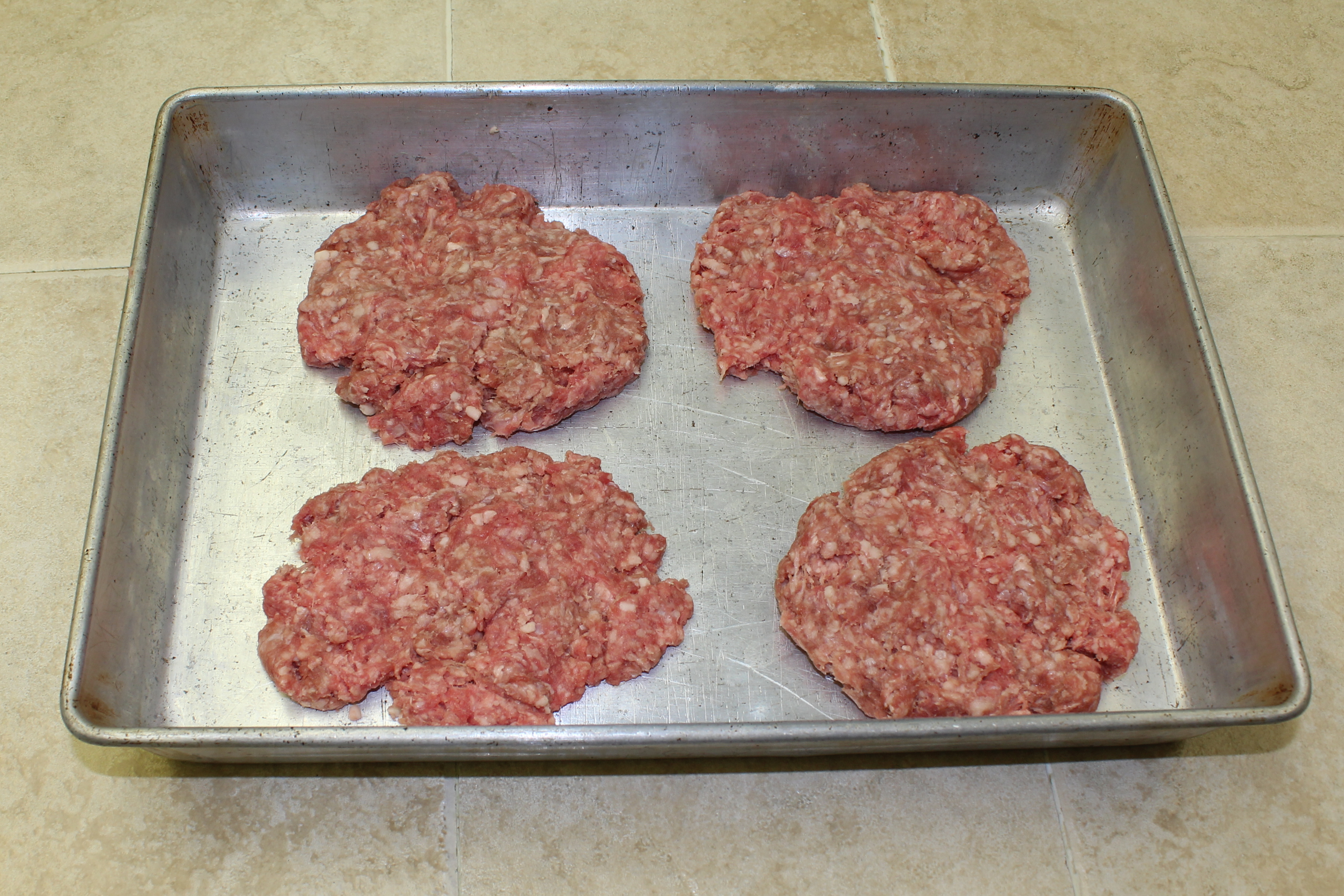 sausage burgers on a cooker sheet