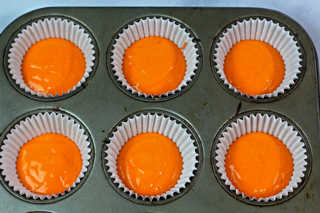 orange cake batter in cupcake wrapper