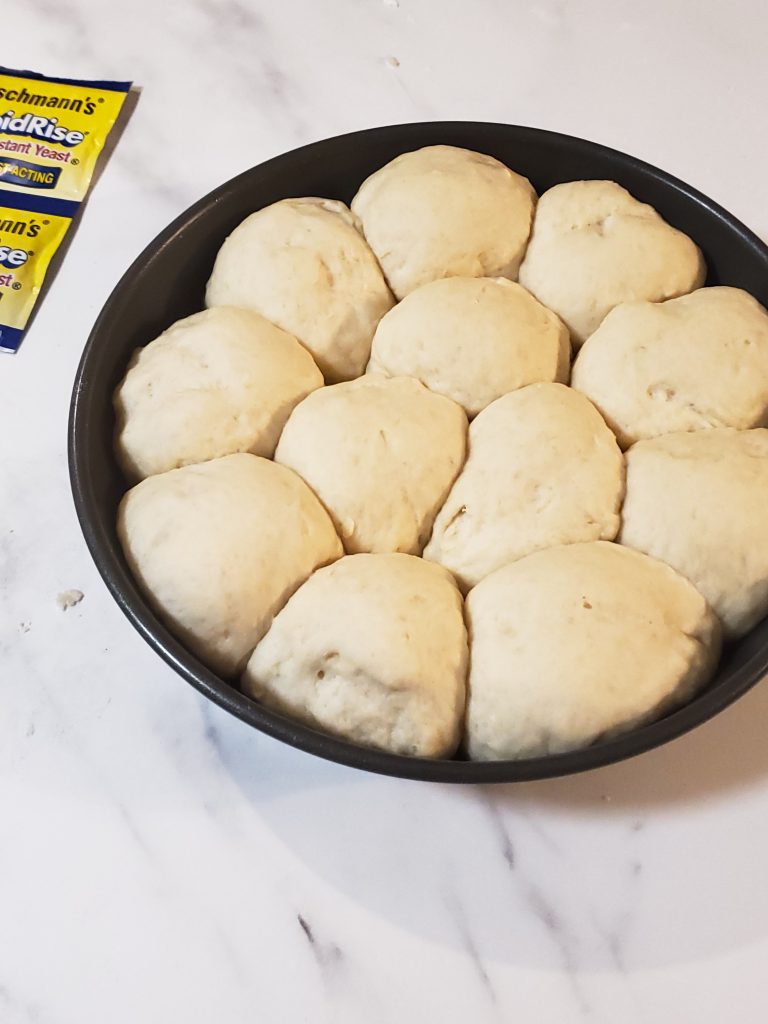 risen homemade rolls in a pan