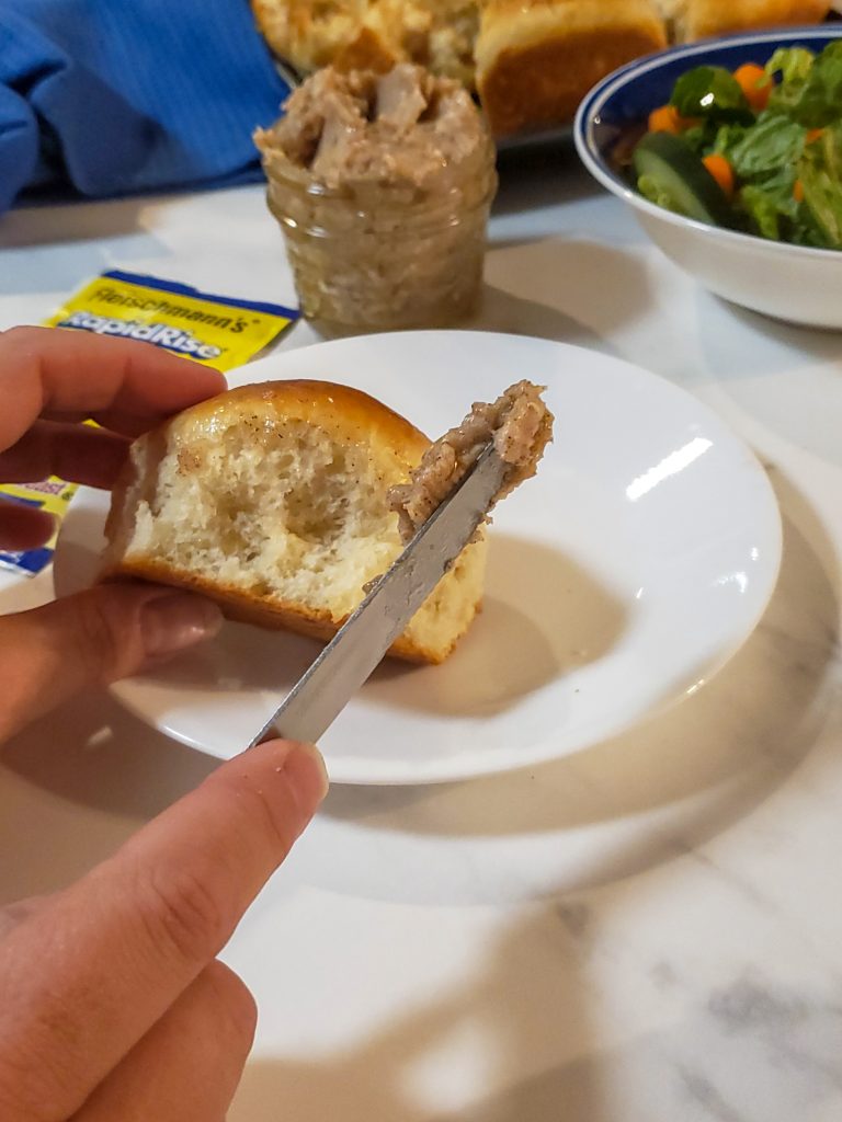 holding a roll with cinnamon butter