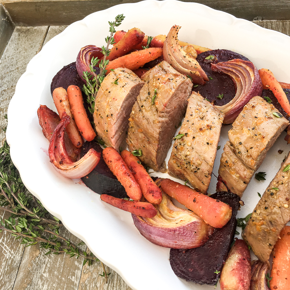 Orange Glazed Pork Loin on a white plate with vegetables