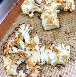 slices of cauliflower steaks on a baking sheet