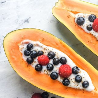 stuffed papaya breakfast bowl with yogurt and fruit