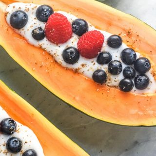 Stuffed Papaya Breakfast Bowl filled with yogurt and fresh fruit