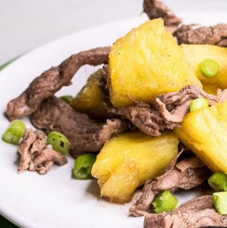 Pineapple Beef Stir Fry on a white and green plate