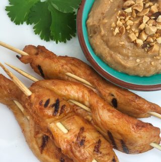chicken satay with a bowl of peanut sauce