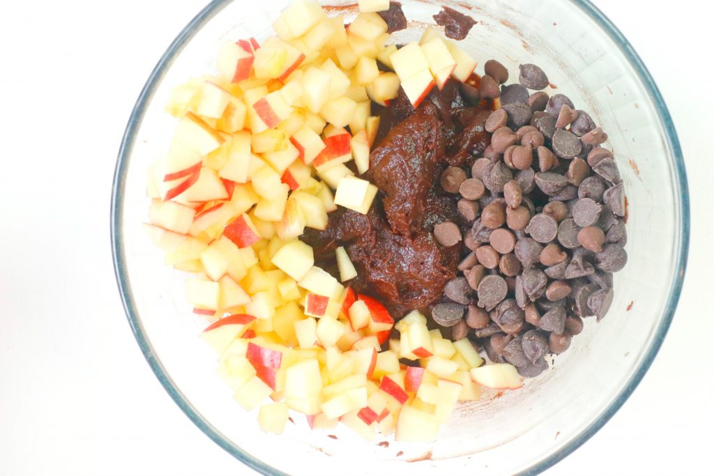 apples and chocolate chips and chocolate pudding in a glass bowl