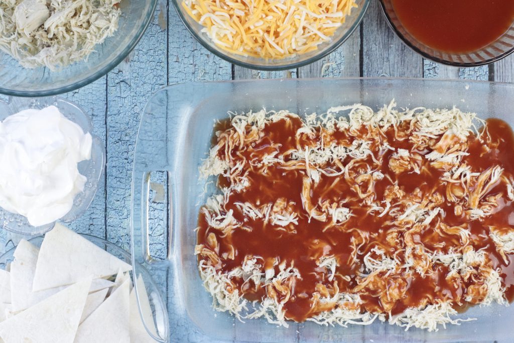 Enchilada sauce layered on top of chicken