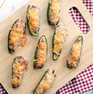 Weight Watchers Stuffed Jalapeno Poppers full of turkey and bacon on a wooden cutting board and on a gingham napkin