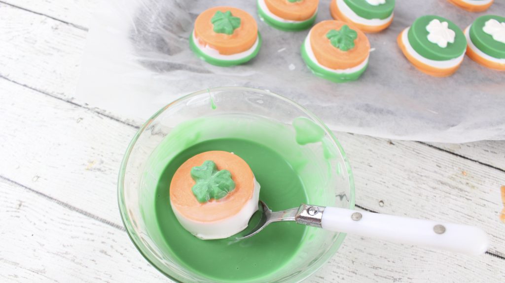 dipping cookie in green chocolate