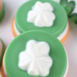 green cookie with a. white shamrock on top