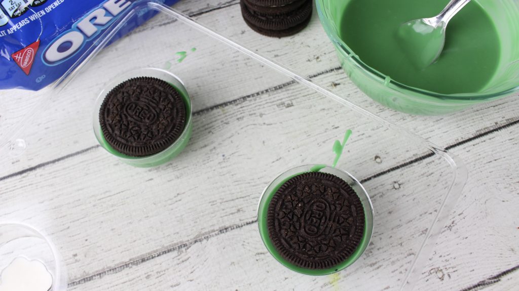 oreo in a cookie mold over green chocolate