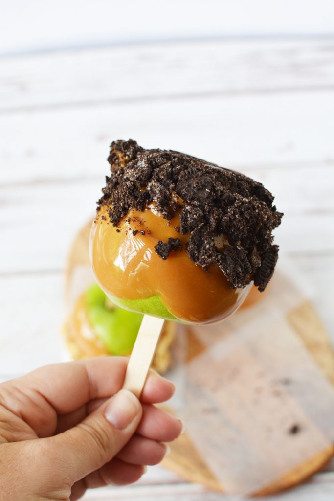 Granny Smith apple dipped in caramel then dipped in crushed oreos