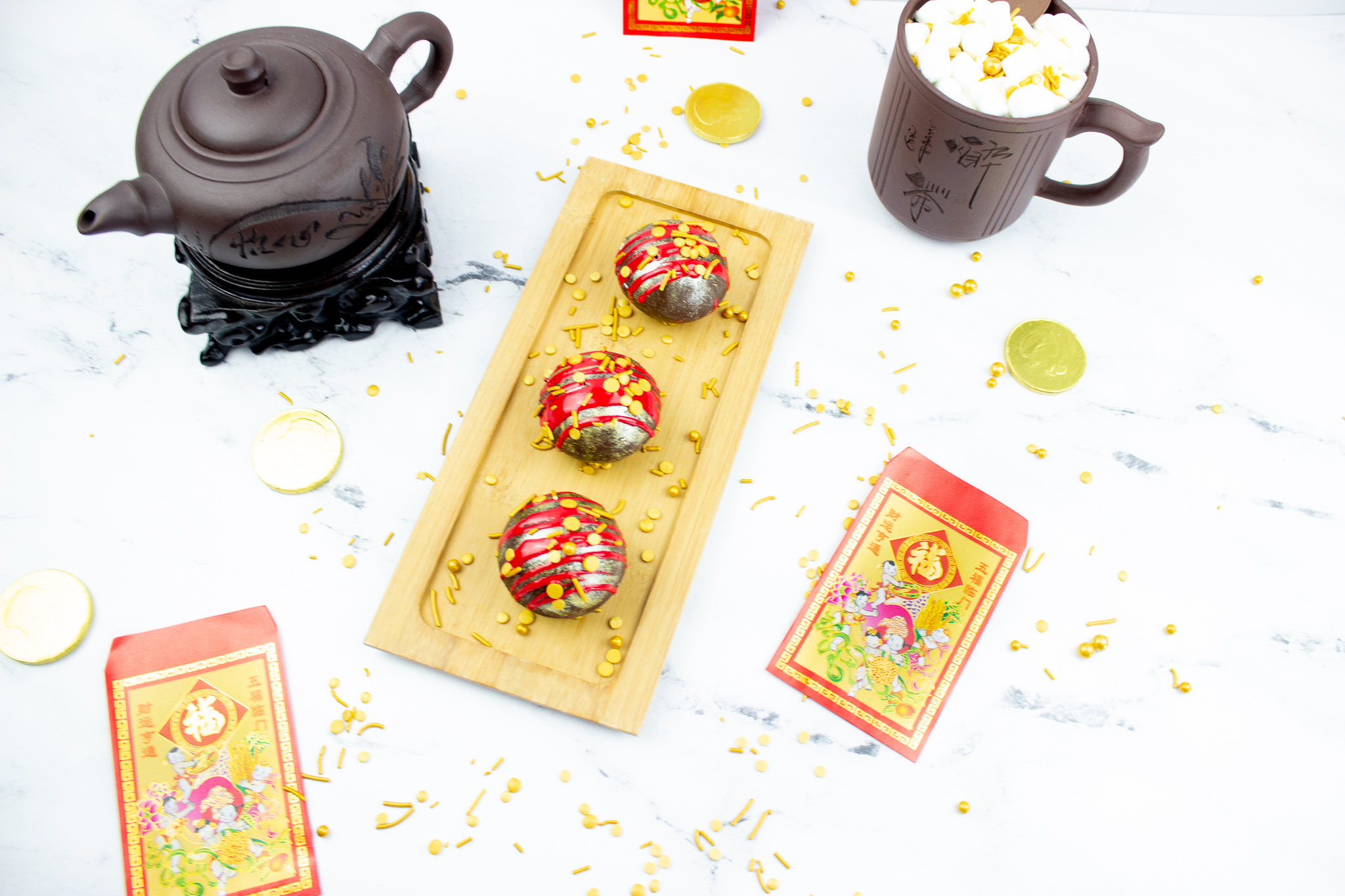3 Chinese new years hot chocolate bombs on a gold plate