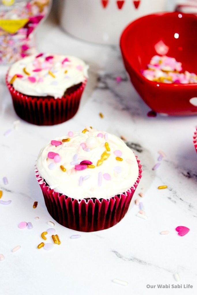 Vanilla frosted cupcakes with Valentines sprinkles in red cupcake liners