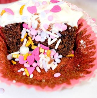 Chocolate Cupcakes with valentine sprinkles inside and topped with vanilla frosting and sprinkles