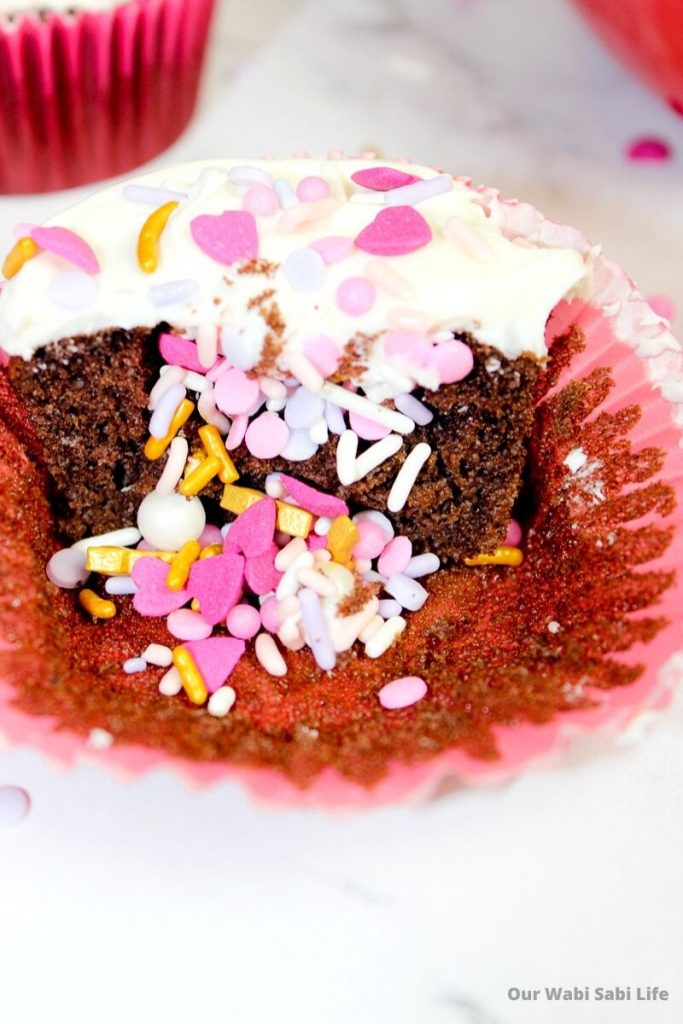 Chocolate Cupcakes with valentine sprinkles inside and topped with vanilla frosting and sprinkles