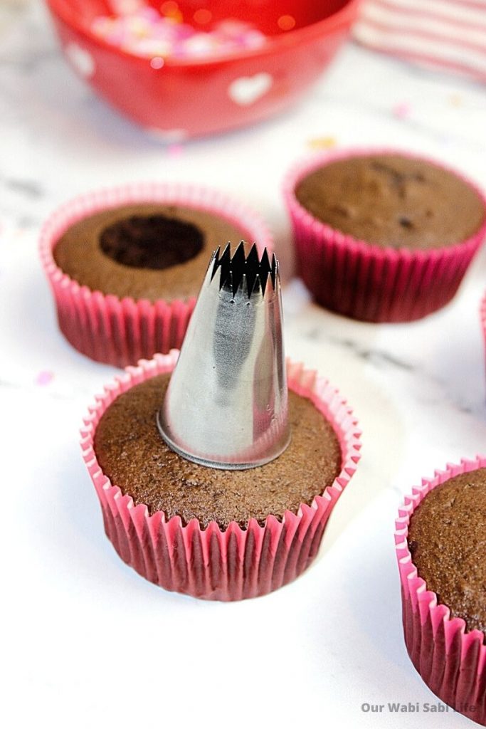 Removing top section of cupcake to add sprinkles