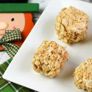 Blarney Stone Squares covered in peanuts and vanilla glaze on a white plate