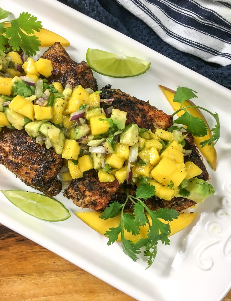 Pieces of snapper that have been seasoned with Cajun seasoning and topped with Avocado Salsa